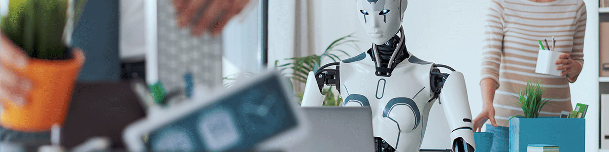 A humanoid robot sitting in an office environment surrounded by people handling plants and technology.